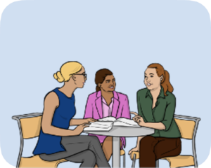 Three people sat around a table having a meeting